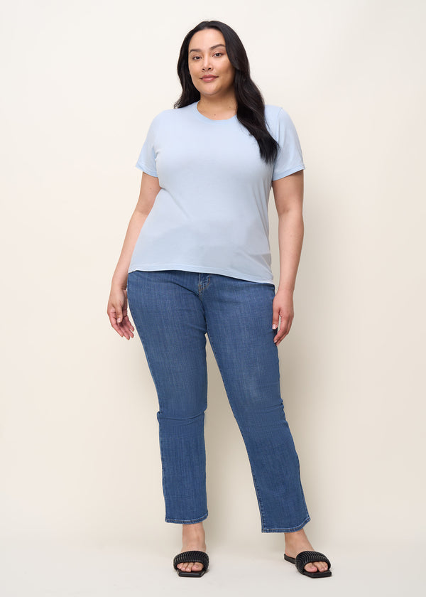 Woman in relaxed fit crew neck t-shirt with short sleeves made of organic and recycled cotton jersey and eco-friendly dyes in sky blue, front