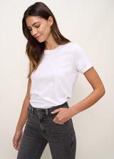 Woman in relaxed fit crew neck t-shirt with short sleeves made of organic and recycled cotton jersey and eco-friendly dyes in true white, front