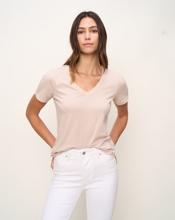 Woman in relaxed fit V neck t-shirt with short sleeves made of organic and recycled cotton jersey and eco-friendly dyes in oat, front