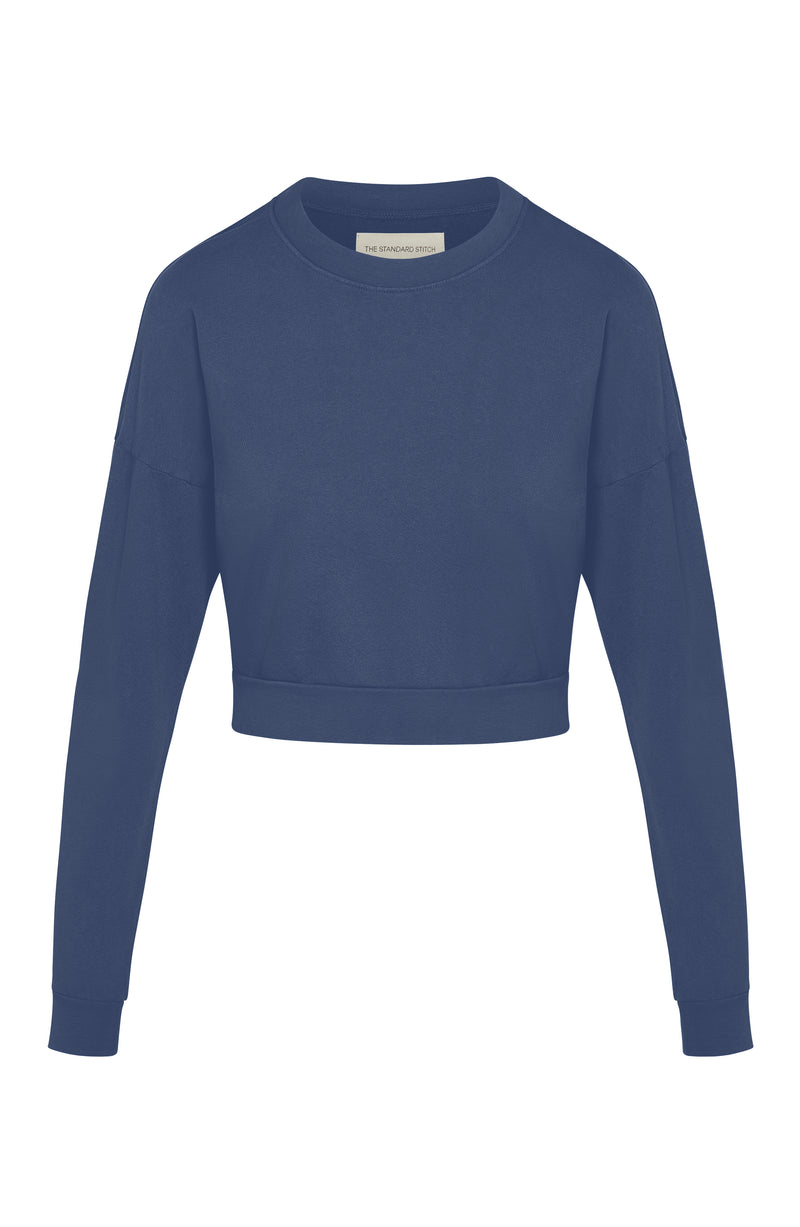 Woman’s crewneck cropped sweatshirt with drop shoulders and length to midriff made of organic and recycled cotton French Terry in color Midnight Navy on mannequin 