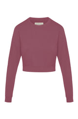 Woman’s crewneck cropped sweatshirt with drop shoulders and length to midriff made of organic and recycled cotton French Terry in color Plum on mannequin 