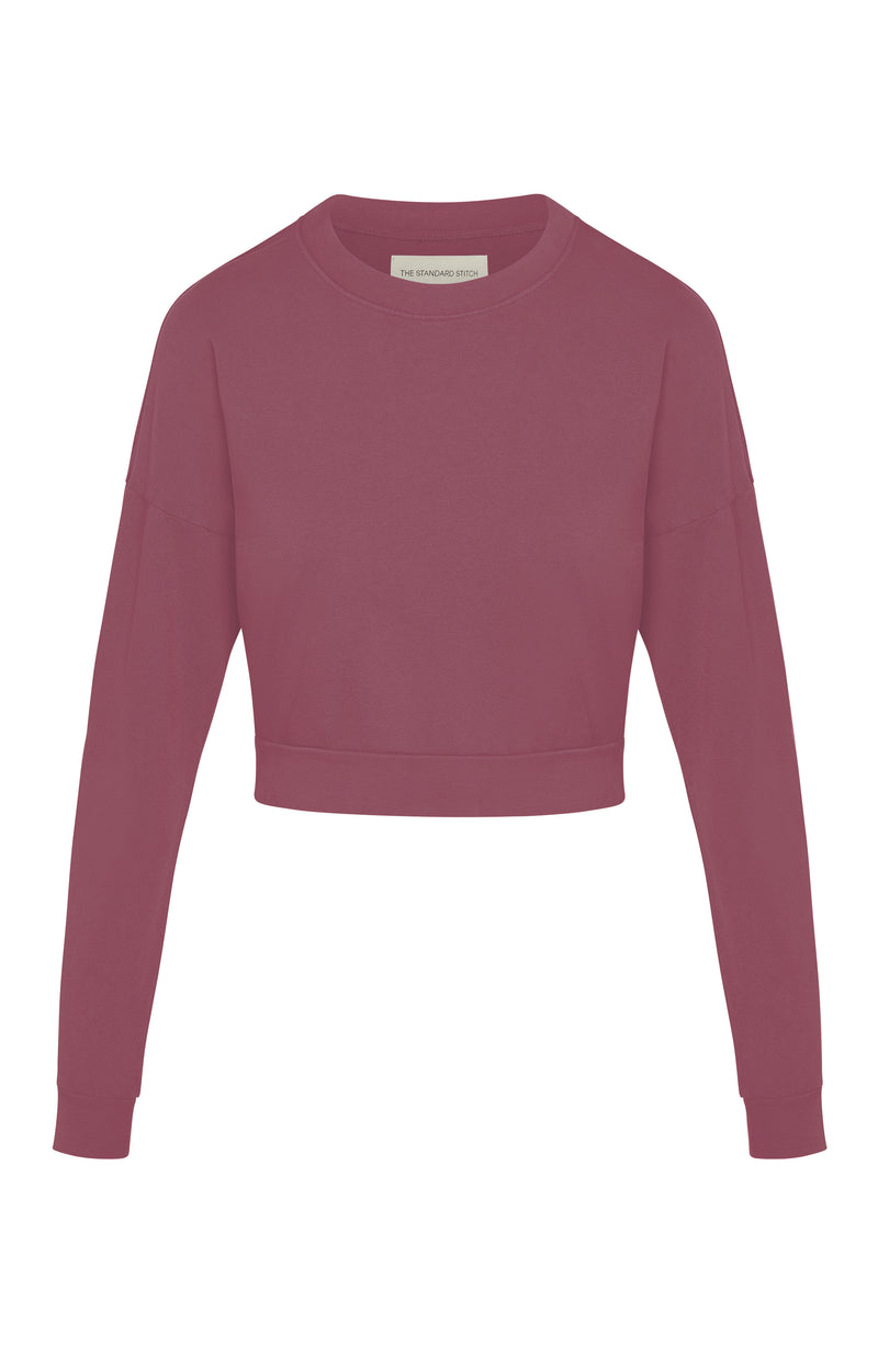 Woman’s crewneck cropped sweatshirt with drop shoulders and length to midriff made of organic and recycled cotton French Terry in color Plum on mannequin 